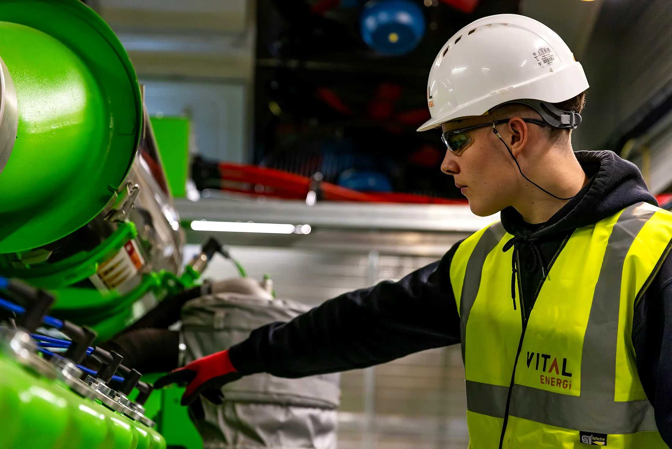 Industrial engineer working on existing production equipment during a safety upgrade