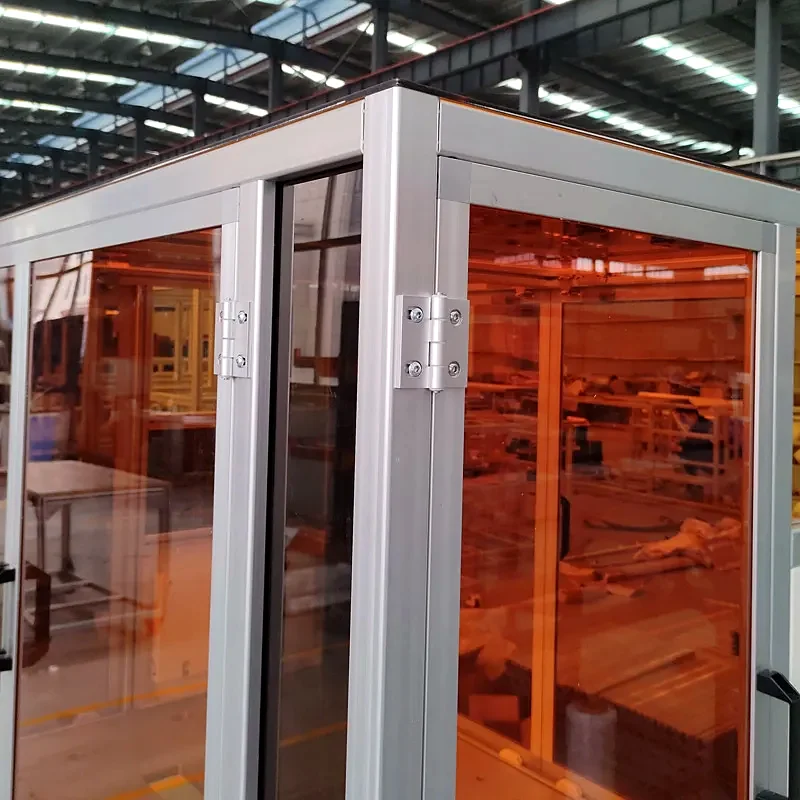 Close-up of aluminium frame and tinted clear panels on a machine safety enclosure